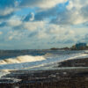 Coastal Waves Under a Cloudy Sky